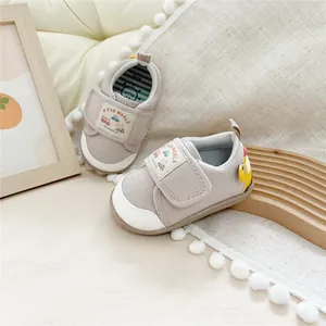 Close-up of soft-sole baby walking shoes with cartoon car and velcro strap