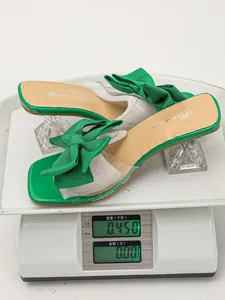 Detail view showing green bow high heel sandals with wine glass heels weighing 450g
