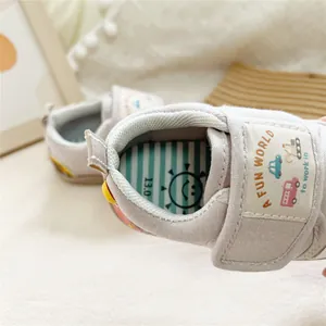 Detail view of Mori style baby walker shoes with cartoon car embroidery and soft sole