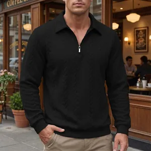 Close-up of black men's polo shirt featuring jacquard texture and half-zip collar.