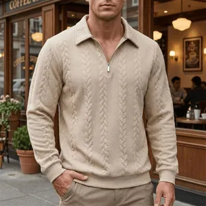 Macro view of men's beige polo shirt showing detailed cable knit pattern and zipper