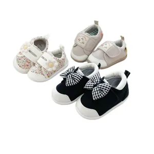 Soft sole baby walking shoes with floral patterns and checkered bow designs for infants