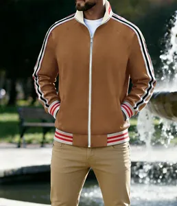Close-up of men's brown athletic jacket with striped tape detail on sleeves