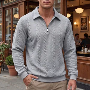 Detailed view of a grey cable knit half-zip polo shirt with textured jacquard pattern for men