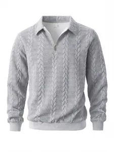 Close-up of gray men's polo shirt with textured jacquard knit and half-zip collar detail