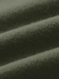 High resolution macro shot showing soft green fleece fabric texture for men's sports jacket