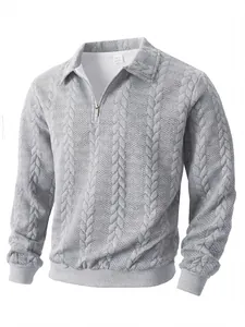 Macro detail of men's gray half-zip polo shirt featuring a textured cable knit pattern.