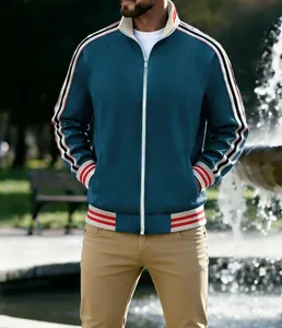 Detailed view of men's blue sports jacket featuring red and white striped ribbed cuffs