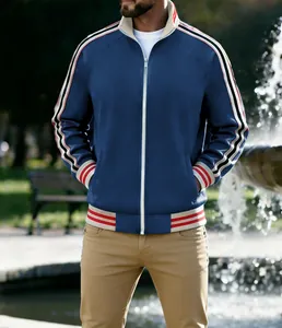 Close-up of the striped ribbed cuffs and blue fabric texture on this sports track jacket