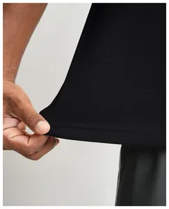 Close-up of breathable quick-dry black sports T-shirt fabric showing stretch and mesh texture.