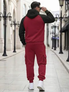 Back view of men's red and black fleece tracksuit with hooded sweatshirt and cargo joggers