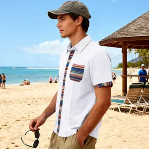 Detail view of men's white beach shirt with Bohemian patterned trims on a beach
