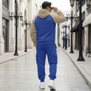 Back view of men's two-piece tracksuit with color-blocked hoodie and cargo pants