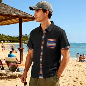 Men's bohemian beach short sleeve shirt with colorful striped trim in a sunny beach setting.
