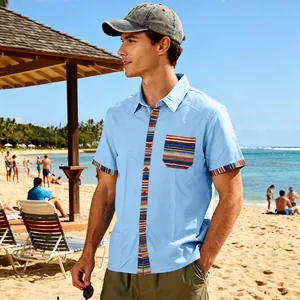 Detailed view of men's bohemian striped beach shirt in light blue on a sunny shore
