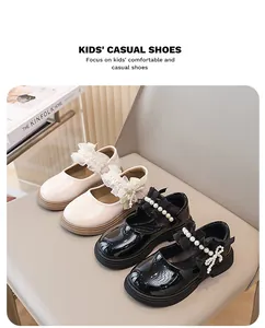 Primo piano di scarpe Mary Jane per bambina con fiocco in perle e pizzo in nero e crema