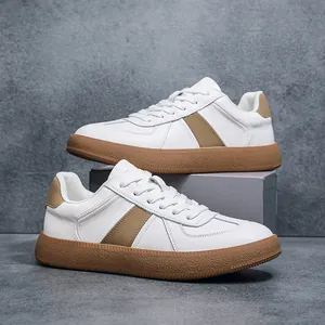 Detailed macro view of leather men's GAT sneakers in white and brown with gum sole.