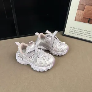 Detailed shot of pink and white mesh sneakers for girls with elegant decorative bow shoelaces