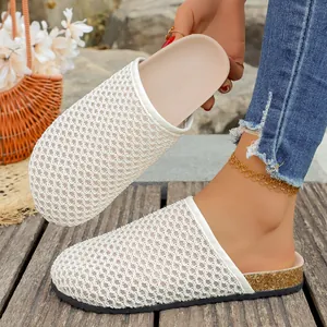 Close-up detail of white woven mesh upper on women's stylish closed-toe summer mules
