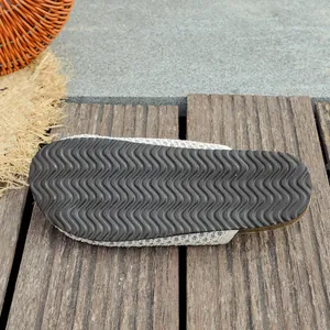 Close-up of anti-slip sole on white woven mesh retro mules for women