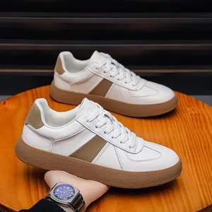 Stylish white leather German army trainers for men with brown gum sole detail view