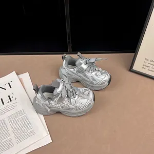 Vista detallada de zapatillas chunky plateadas de malla para niñas con lazos y flores decoradas