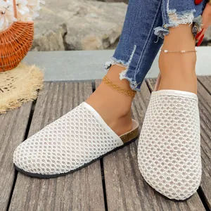 Detail of white woven mesh flat mule slippers for vintage summer holiday style
