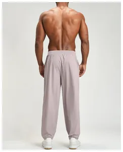 Rear view of men's quick-dry sports pants in dusty rose perfect for hiking and leisure
