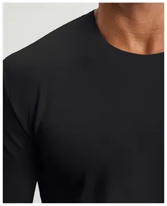Detail of breathable mesh fabric on black round neck long sleeve athletic t-shirt.