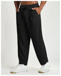 Macro view of men's black quick-dry athletic trousers showing straight leg fit and pockets.
