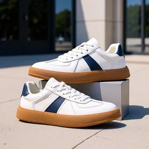 Classic men's white leather German army trainers with navy stripes and gum soles.