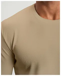 Close-up showing the breathable mesh fabric texture and crew neck of a khaki athletic shirt