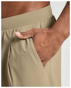 Detail shot of the side pocket and breathable fabric of khaki hiking trousers