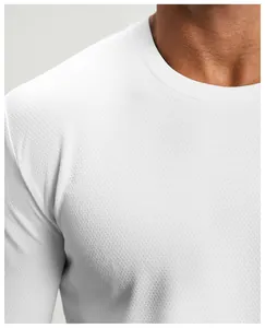 Detail view of white round neck athletic long sleeve shirt with mesh texture