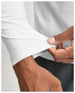 Close-up detail of white quick-dry sports shirt showing breathable mesh fabric texture.