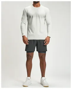 Full-body shot of a man wearing a breathable grey long-sleeve sports shirt