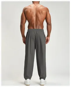 Detailed back view of gray men's quick-drying sports hiking pants on a muscular model