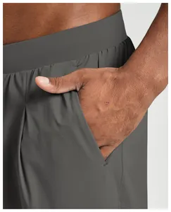 Close-up of pocket and elastic waist on men's dark grey quick-dry sports pants
