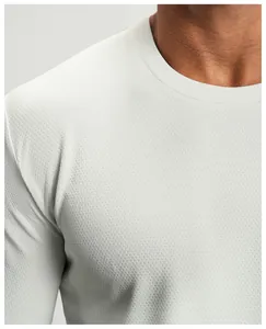 Close-up of white quick-dry athletic long sleeve shirt with breathable mesh texture.
