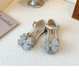 Glittery silver girls princess shoes with rhinestone bows and pearl straps for parties.