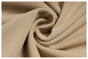 Macro view of breathable quick-dry athletic fabric showing fine mesh texture and soft drape