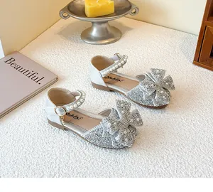 Detailed view of silver glitter girls' princess shoes with pearl bow and strap decorations.