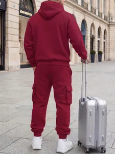Back view of a men's burgundy hooded tracksuit with cargo pants in a city setting
