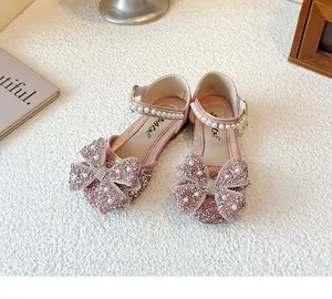 Detailed view of pink girls princess shoes with sparkling rhinestones and pearl straps