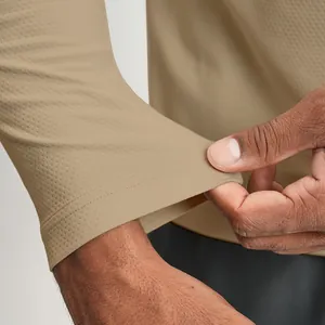 Detailed view of the breathable mesh fabric on a khaki quick-dry athletic long sleeve shirt.