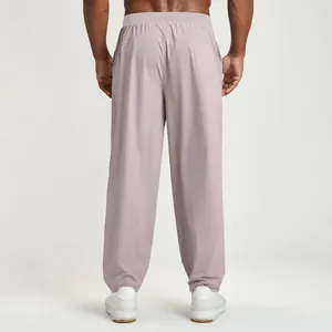 Lightweight men's quick-dry casual sports pants in mauve color shown from the back