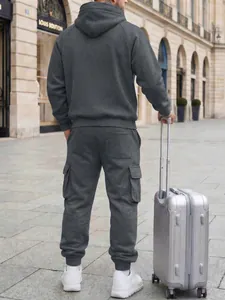Back view of a men's stylish grey hooded tracksuit featuring cargo joggers in urban setting