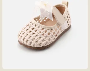 Close-up detail of cream woven baby girl princess shoes with delicate lace bow accent