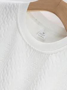 Close-up detail of white jacquard knit texture on a men's crew neck casual top