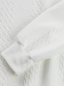 Detailed macro view of white jacquard knitted fabric and ribbed cuff on men's top